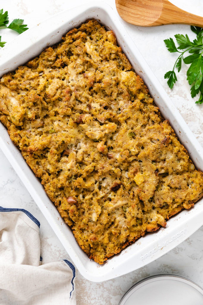 Baked chicken and dressing in a pan.