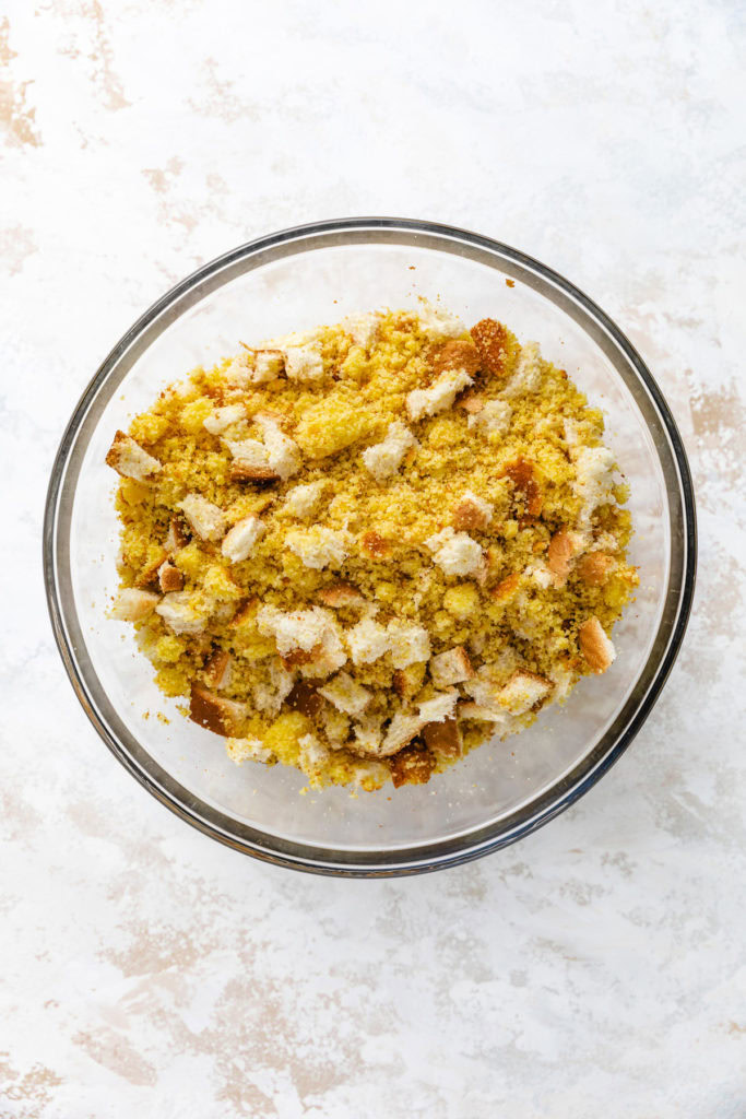 Cornbread and white bread crumbled in a bowl.