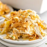 Scoop of french onion chicken casserole on two plates.