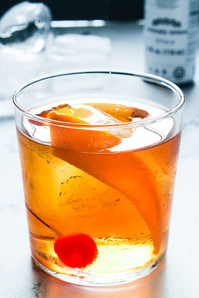 Cocktail with cherry and orange.