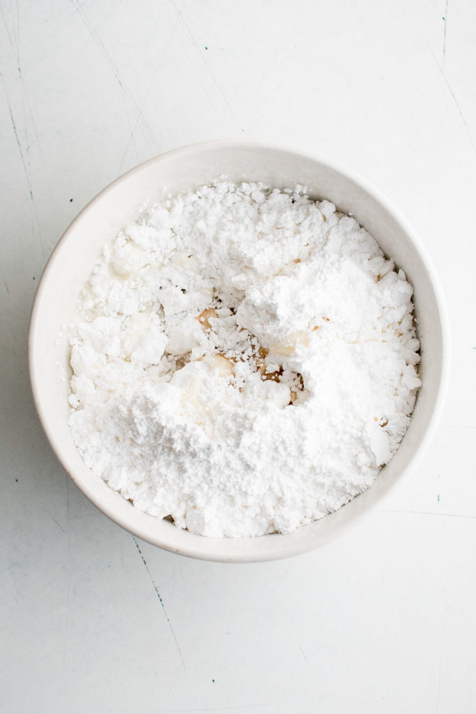 Bowl of powdered sugar, butter and vanilla.