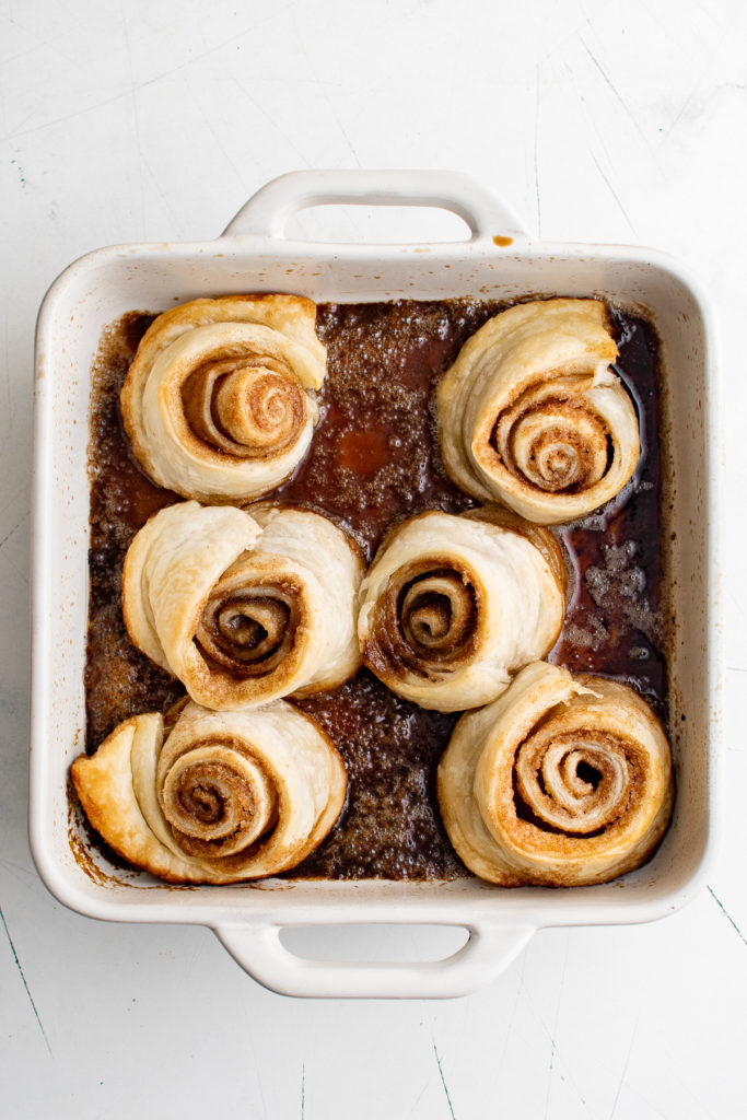 Baked cinnamon rolls in a dish.