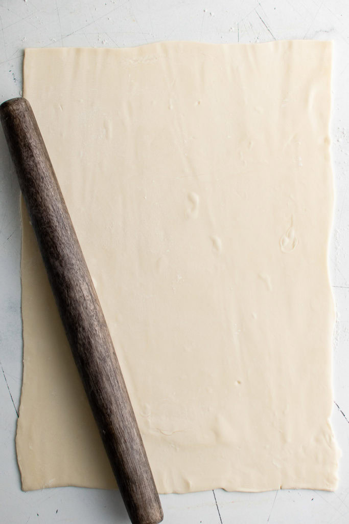 Puff pastry rolled out with a rolling pin.