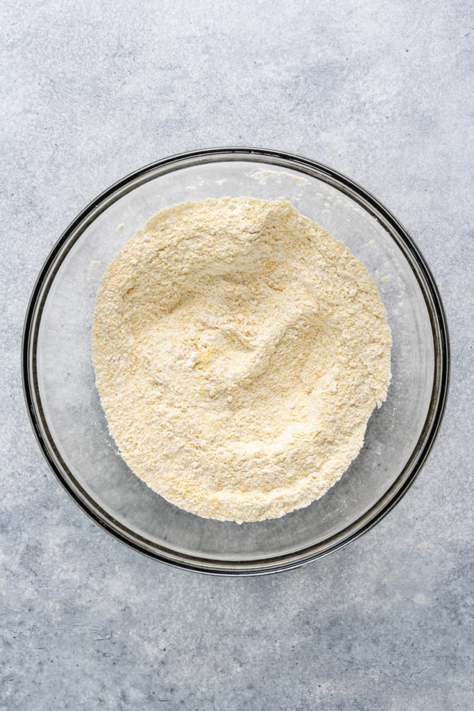 Cornmeal, flour, baking powder and salt whisked together in a bowl.