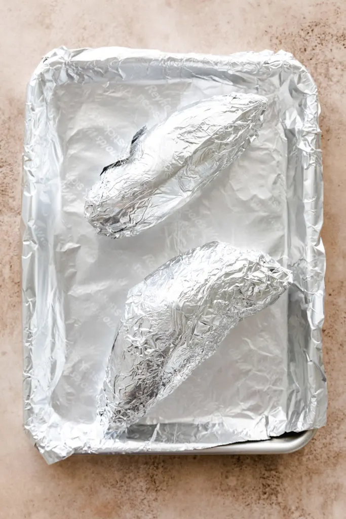 Sweet potatoes wrapped in foil.