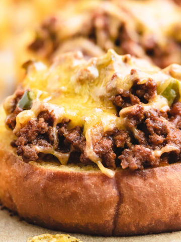 Close up of melted cheese on top of texas toast sloppy joes.