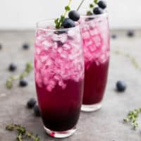 Blueberry cocktail with thyme over ice.