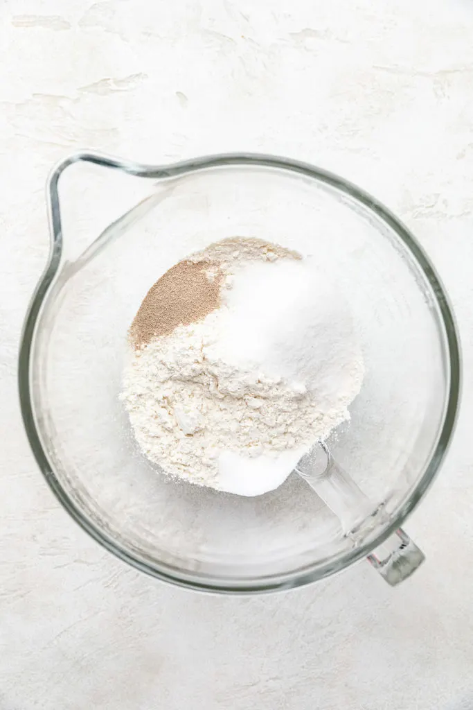 Flour, sugar, yeast and salt in a bowl.