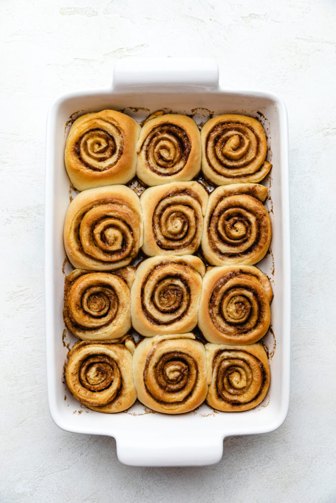 Sweet rolls without icing in a baking dish.
