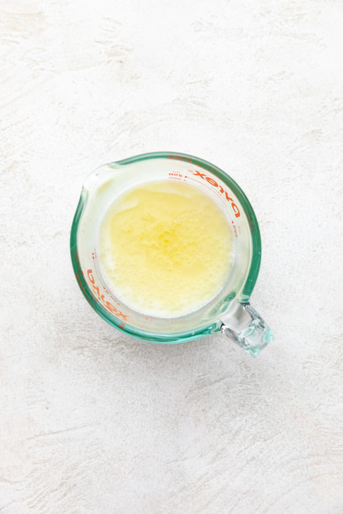Melted butter, milk and water in a measuring cup.