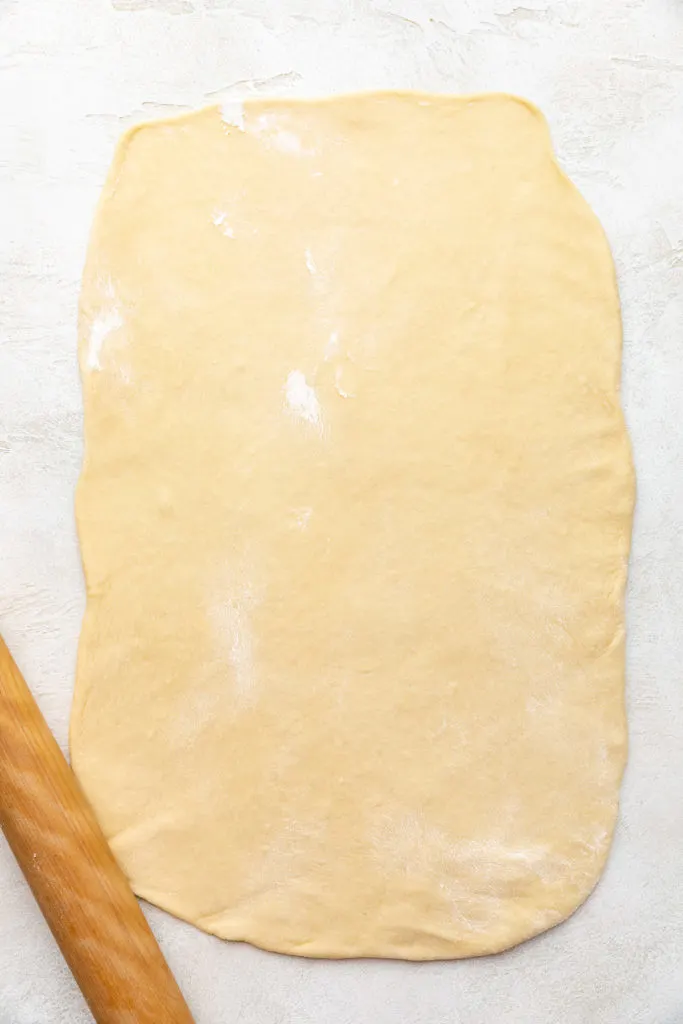 Dough rolled out on a board.