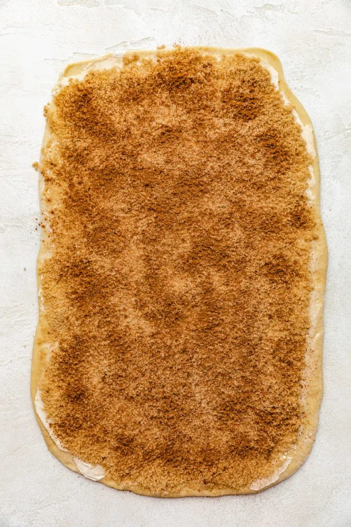 Butter, brown sugar, cinnamon and butter spread over dough.