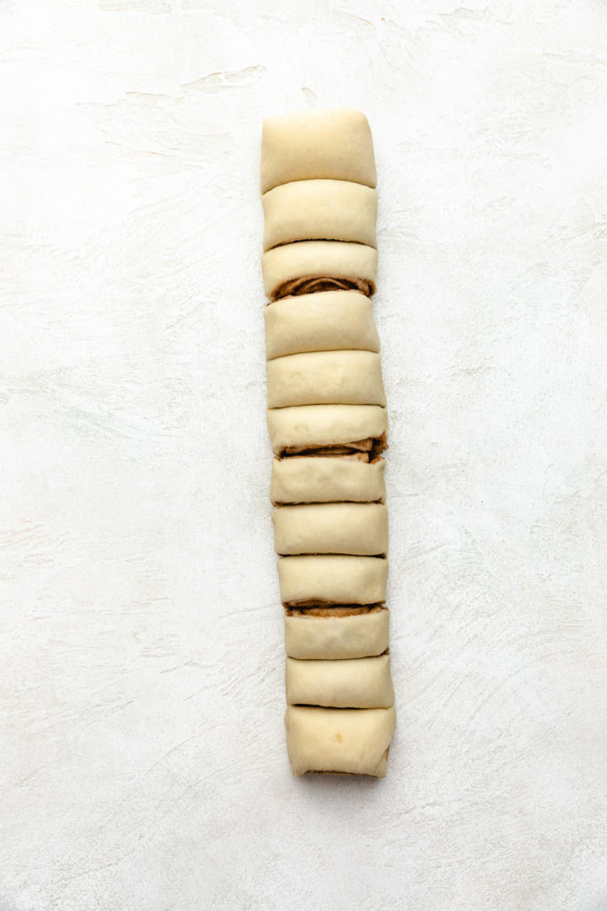 Unbaked cinnamon rolls in a log.