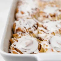 Side view of sweet buns in a baking dish.