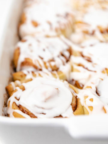 Side view of sweet buns in a baking dish.