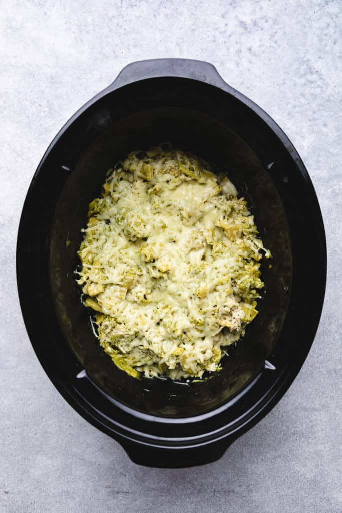 Top down view of chicken pesto pasta in a crockpot.