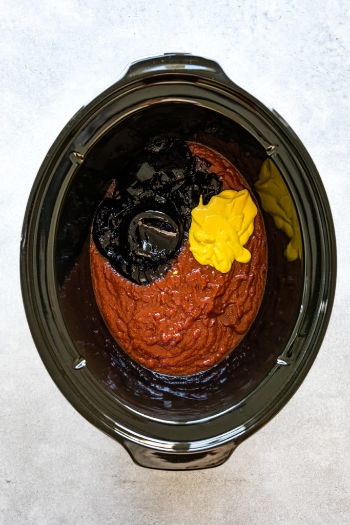 Chili sauce, grape jelly and mustard in a slow cooker.