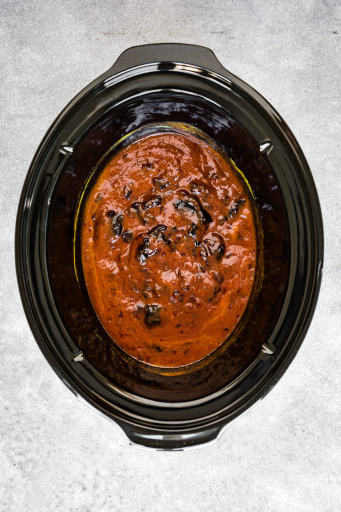 Chili sauce, grape jelly, and mustard stirred together in a slow cooker.