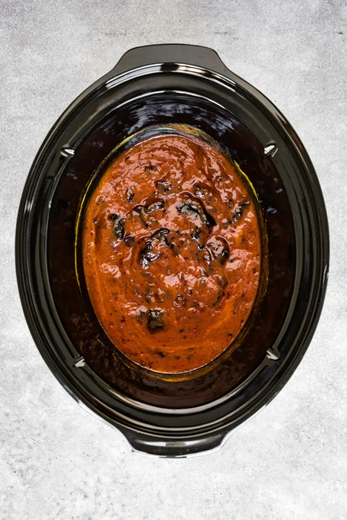 Chili sauce, grape jelly, and mustard stirred together in a slow cooker.