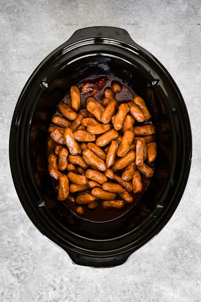 Cocktail sausages stirred in a chili sauce.