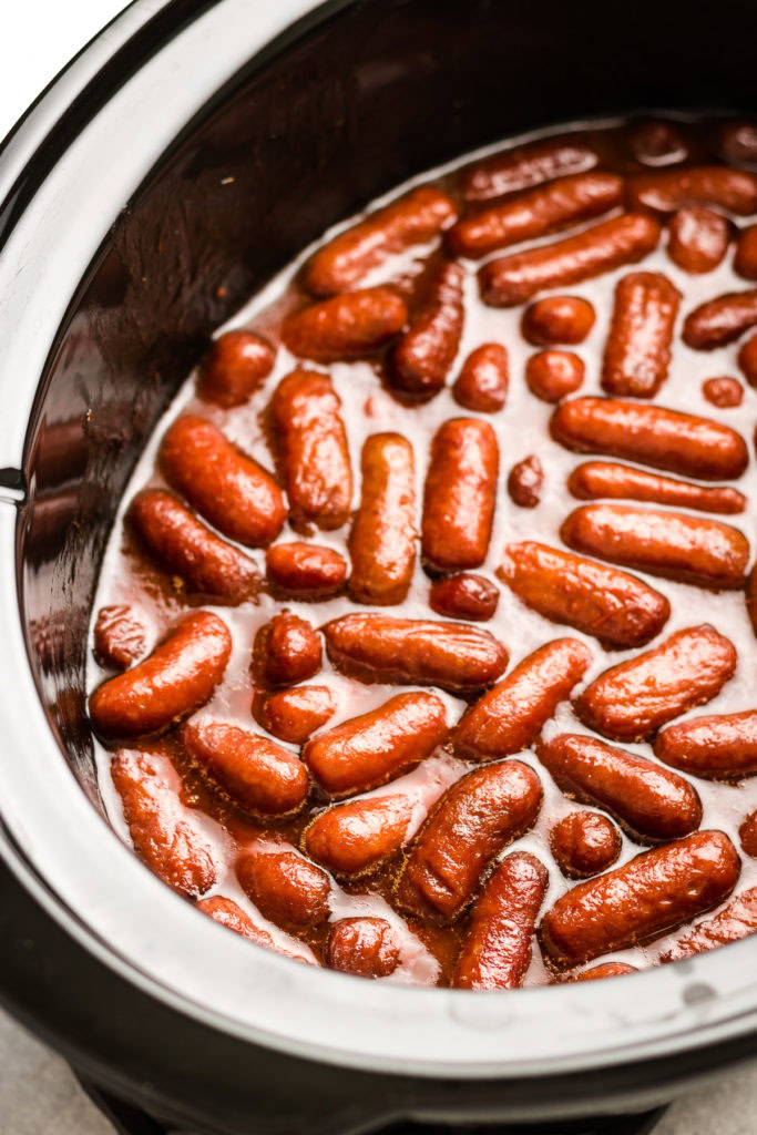 Close up view of little smokies in a crockpot.