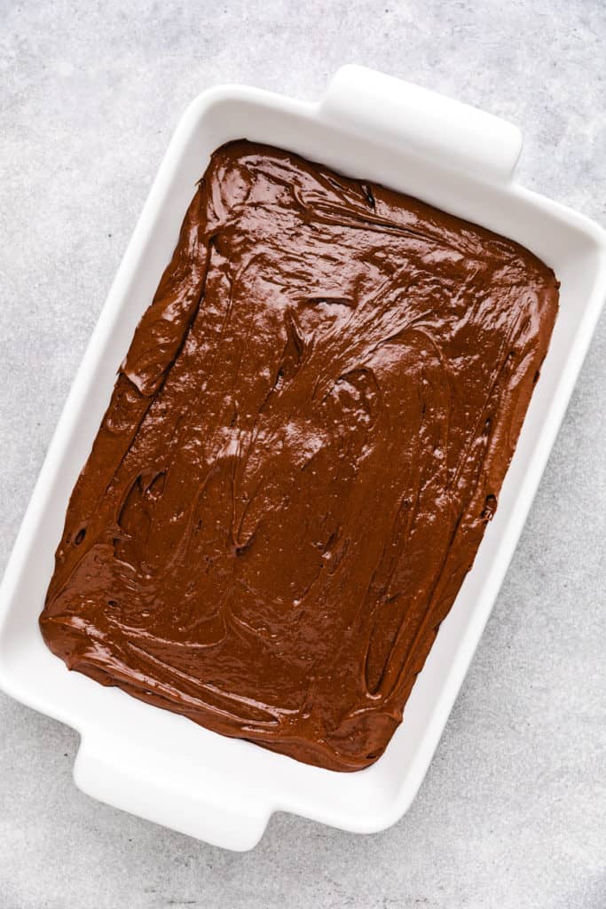 Chocolate cake batter in a cake pan.