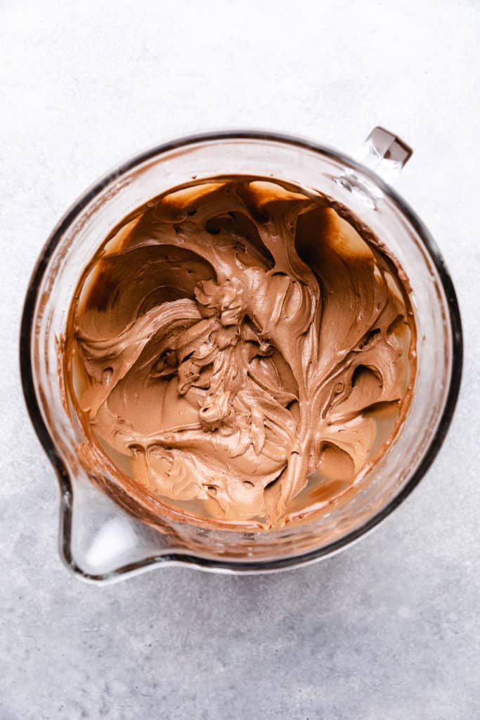 Chocolate frosting in a bowl.