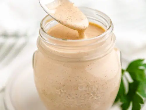 Close up view of spicy ranch dressing on a spoon.