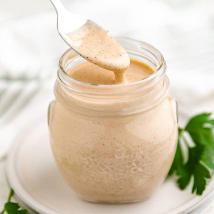 Close up view of spicy ranch dressing on a spoon.