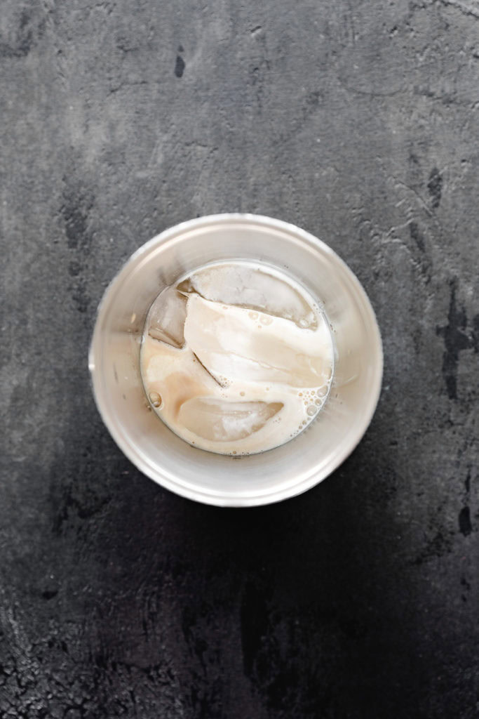 Shaker cup with ice, irish cream, and half and half.