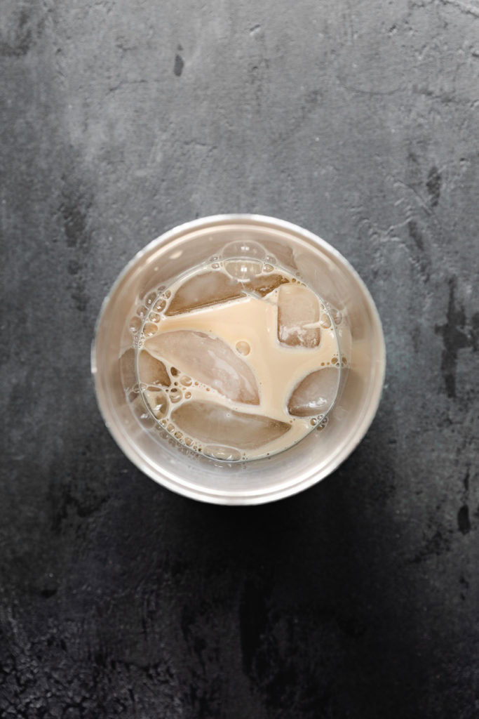 Shaker cup with sugar cookie martini cocktail.