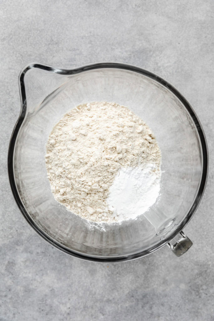 Masa and baking soda in a mixing bowl.