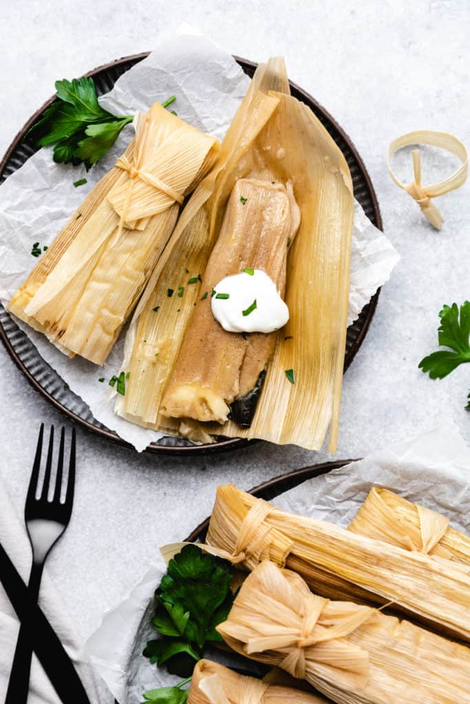 Open tamale laying on a corn husk.