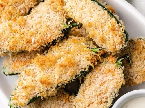 Close up view of jalapeño poppers on a plate.