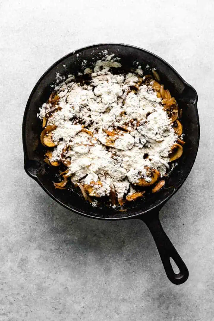 Flour sprinkled over mushrooms and onions.