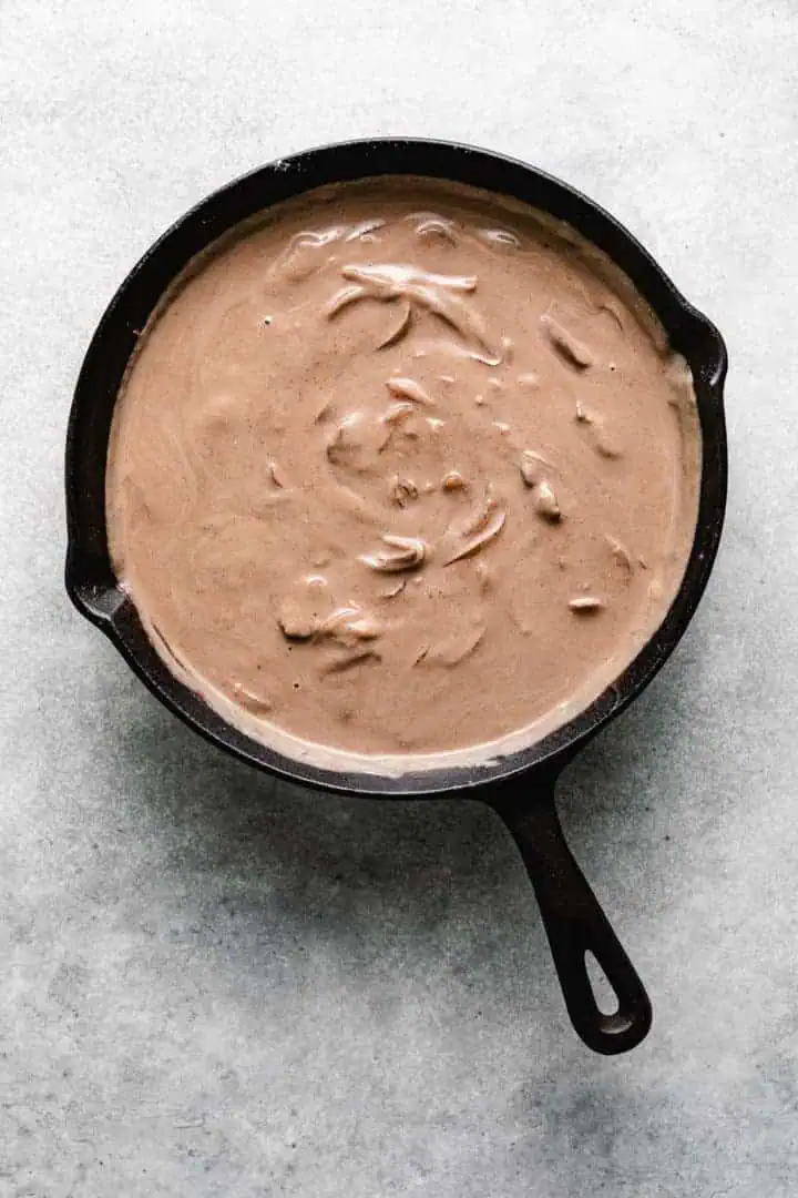 Sour cream sauce cooking in a pan.
