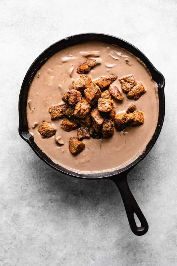 Cubed beef added to a mushroom cream sauce.