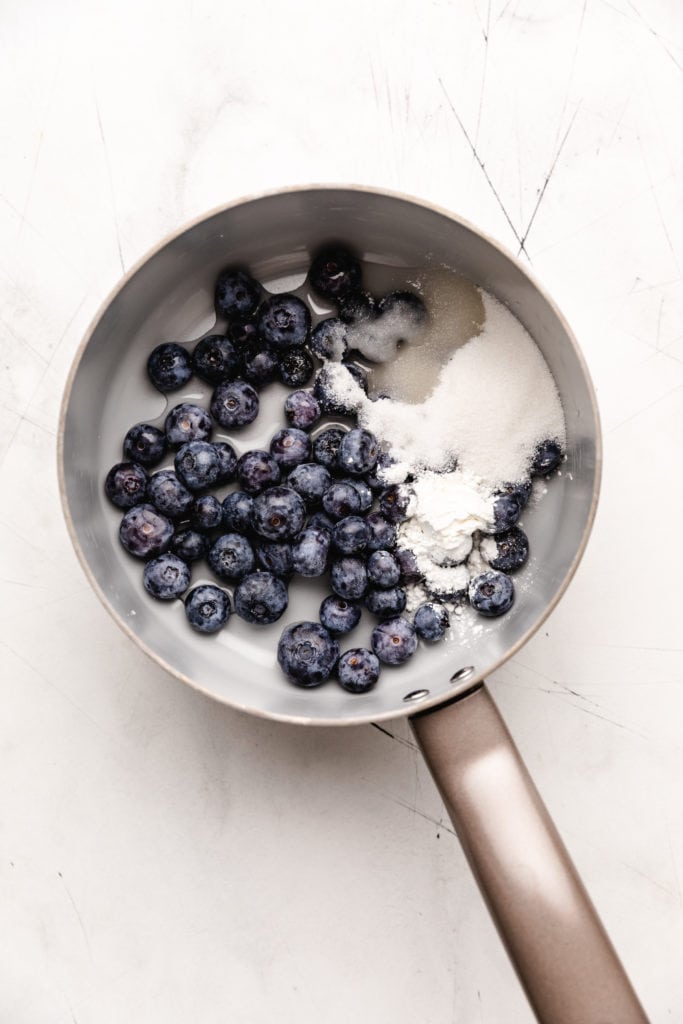 Blueberries, cornstarch, water, and sugar in a pan.