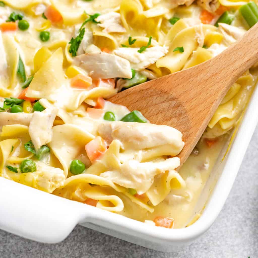 Close up view of creamy chicken noodle casserole in a casserole dish.
