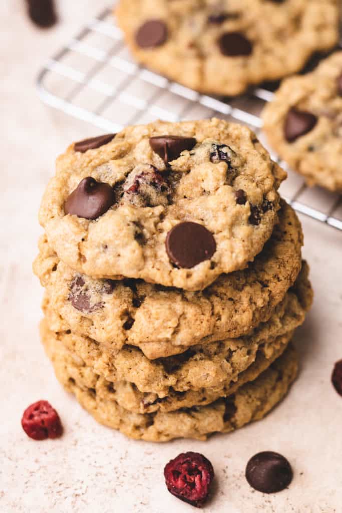 Close up view of a stack of oat cookies with cranberries and chocolate.