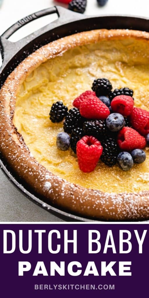 Close up view of a German pancake topped with fresh berries.