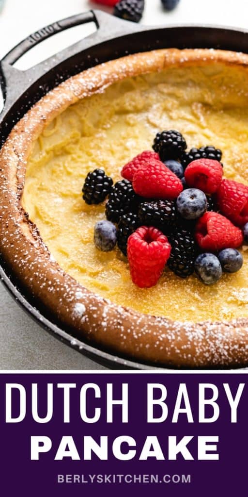 Close up view of a german pancake topped with fresh berries.