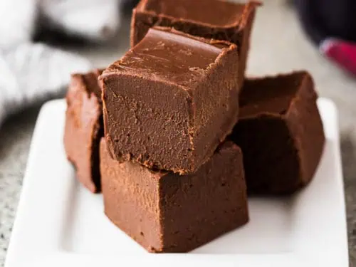 Stack of bailey's irish cream fudge on a white plate.