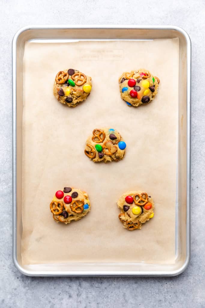 Cookie dough mounds on a baking sheet.