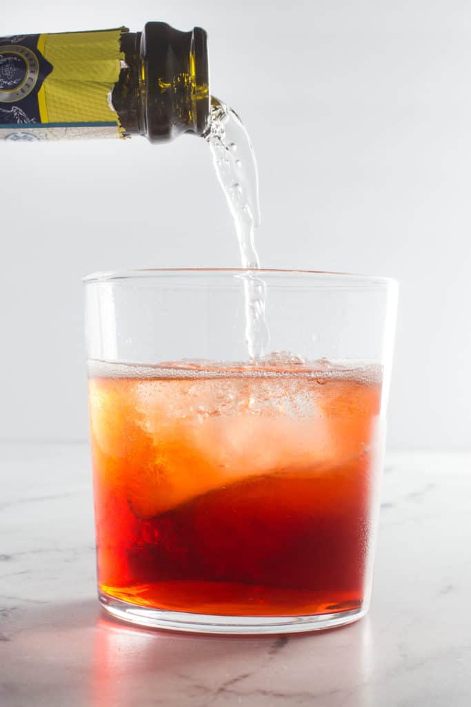 Prosecco being poured into a cocktail glass.