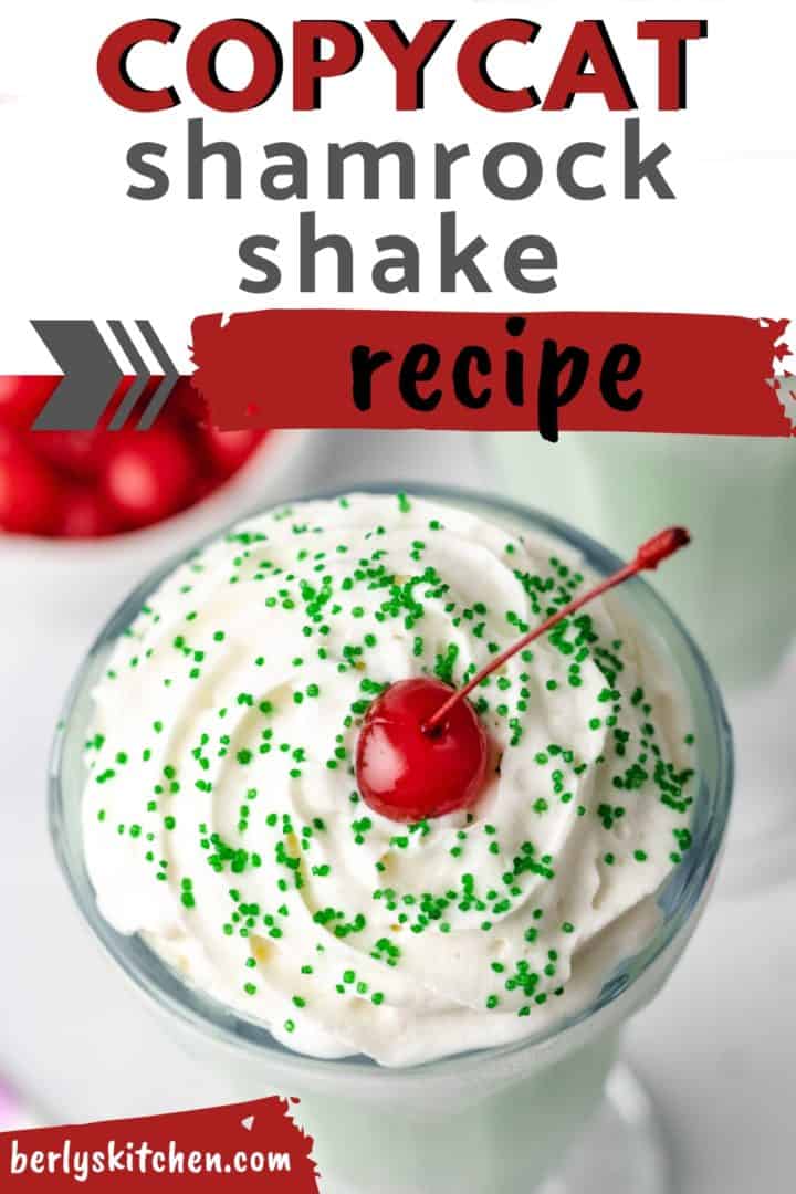 White whipped cream with green sprinkles on a shake.