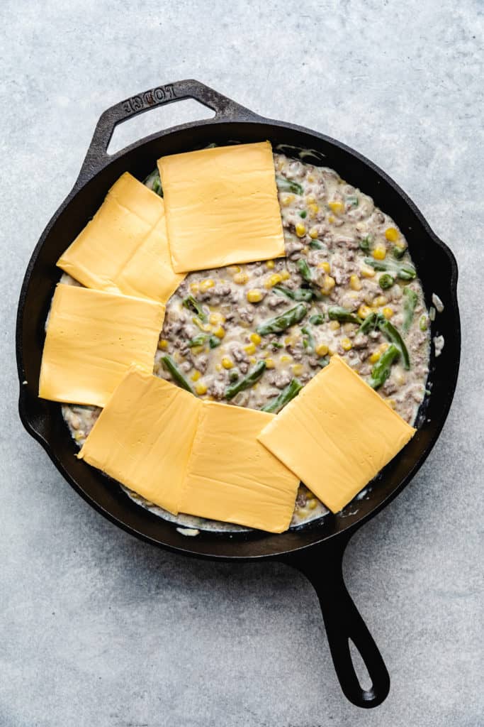 Cheese slices on top of a ground beef casserole.