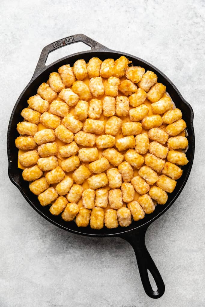 Frozen tater tots on top of a casserole.