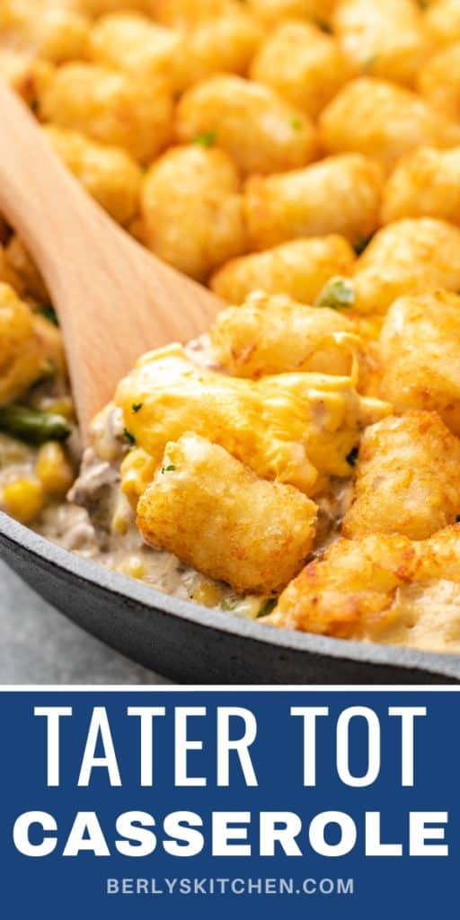 Close up view of tater tot casserole in a cast iron pan.