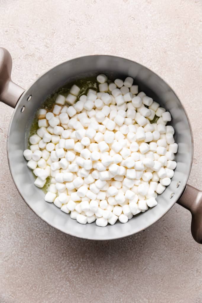 Mini marshmallows in a pan of melted butter.